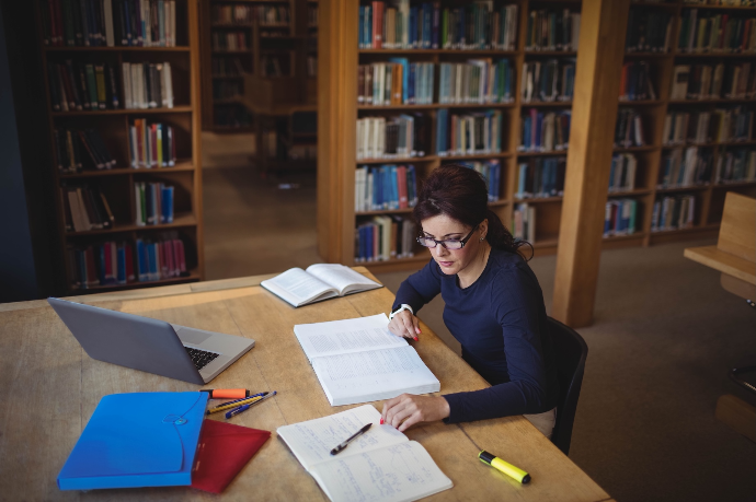 A woman is studying in the library